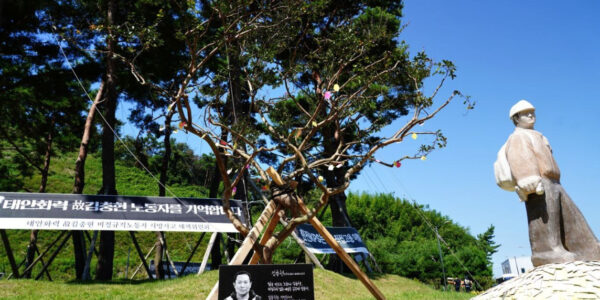 추모비와 추모목, 뒤로 김용균 노동자 추모 조형물이 보인다