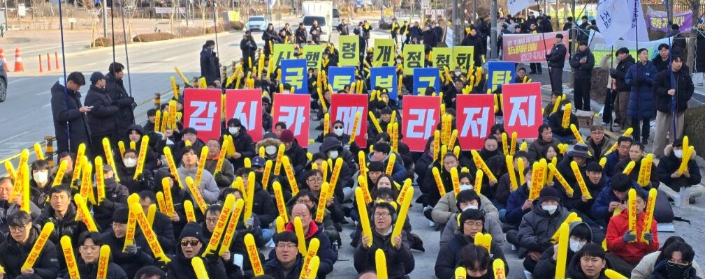 14일 오후 세종시 국토교통부 정문 앞에서 열린 '운전·승무 확대간부 결의대회'에서 정주회 철도노조 운전국장이 삭발을 마친 뒤, 참가자들과 함께 '시행령 입법예고'와 '감시카메라' 문구가 적힌 현수막을 찢으며 정부의 CCTV 설치 강행에 항의하는 상징의식을 거행하고 있다.