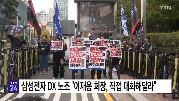 2026년 10월 19일 서울 서초구 삼성전자 서초사옥 앞에서 삼성전자노동조합 동행 등 노조 관계자들이 이재용 삼성전자 회장의 직접 사과와 대화를 촉구하고 있다. 이날 손용호 동행노조 위원장은 지난 16일 수원사업장에서 경호 인력과 충돌한 뒤 입원 치료를 받던 중 환자복 위에 검은색 노조 조끼를 걸치고 기자회견에 참석했다. (출처=YTN 뉴스 영상 갈무리)